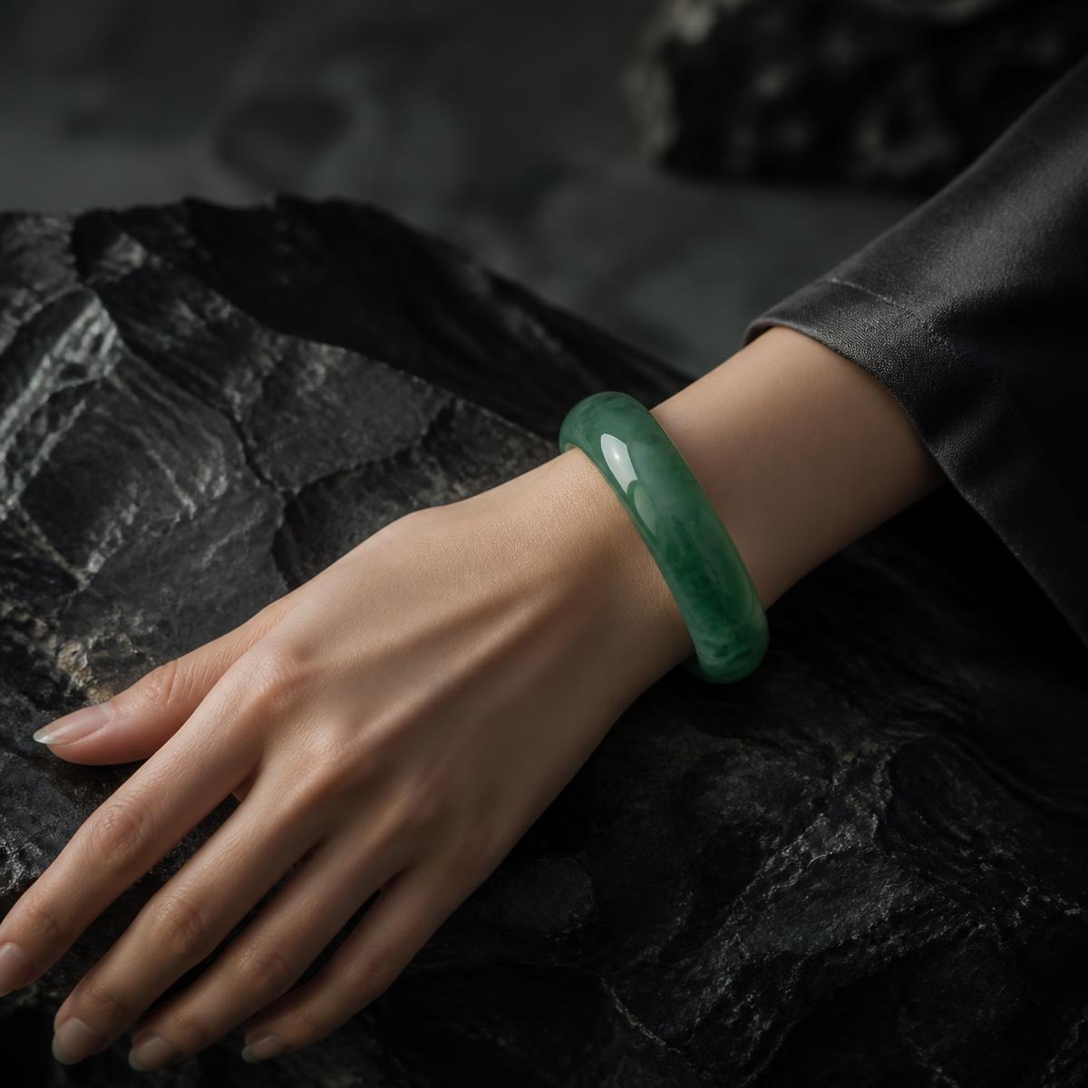 Polished jade bangle cuff worn on the wrist, full piece visible — delivered in Flushing, Queens